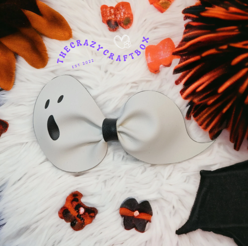 Whiskers n Bows white ghost-shaped faux leather hair bow for Halloween on a white faux fur background