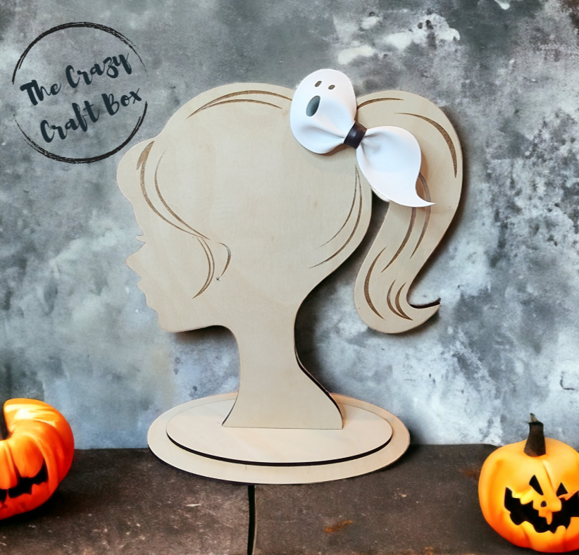 Whiskers n Bows white ghost faux leather hair bow displayed on a wooden mannequin head with Halloween pumpkins